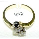 An 18ct gold two stone diamond cross-over ring