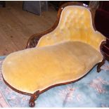 A Victorian mahogany framed chaise longue with serpentine seat and button back rest