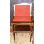 An Edwardian inlaid rosewood fold-over games table with under-tier