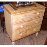 A stripped pine chest of two short and two long drawers with turned wood handles