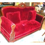 A 19th century carved mahogany framed settee with seat, back and arm rests upholstered in red velour