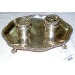 An Edwardian silver desk pen/ink stand with shaped gadrooned rim and lion's paw feet by Crichton