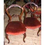 A set of four 19th century dining chairs with cabriole front supports and shaped back rests