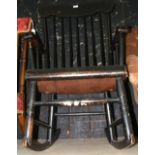 An ebonised stick back rocking armchair