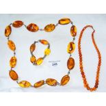 Selection of amber coloured beads and necklets