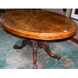 A Victorian inlaid walnut loo table on carved quadruple supports