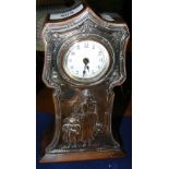 A 22cm high mantel clock timepiece with embossed silver front