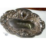 A small embossed silver pin dish