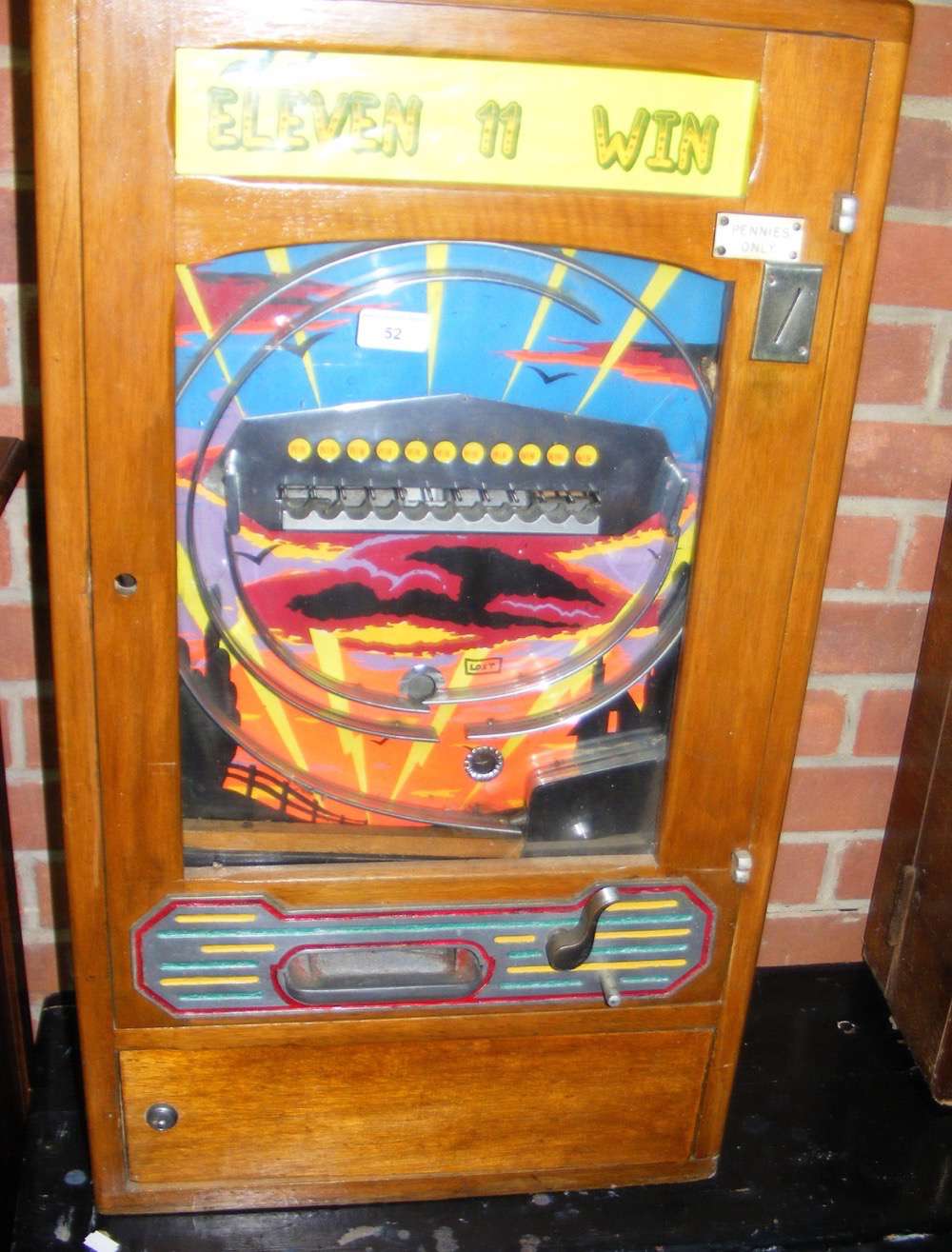 A penny in the slot "Eleven 11 Win" pinball type amusement arcade machine