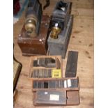 Two metal and brass magic lanterns, together with a large quantity of magic lantern slides