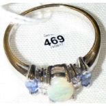 A 14k gold tanzanite, opal and diamond ring