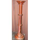 An antique style turned torchere stand