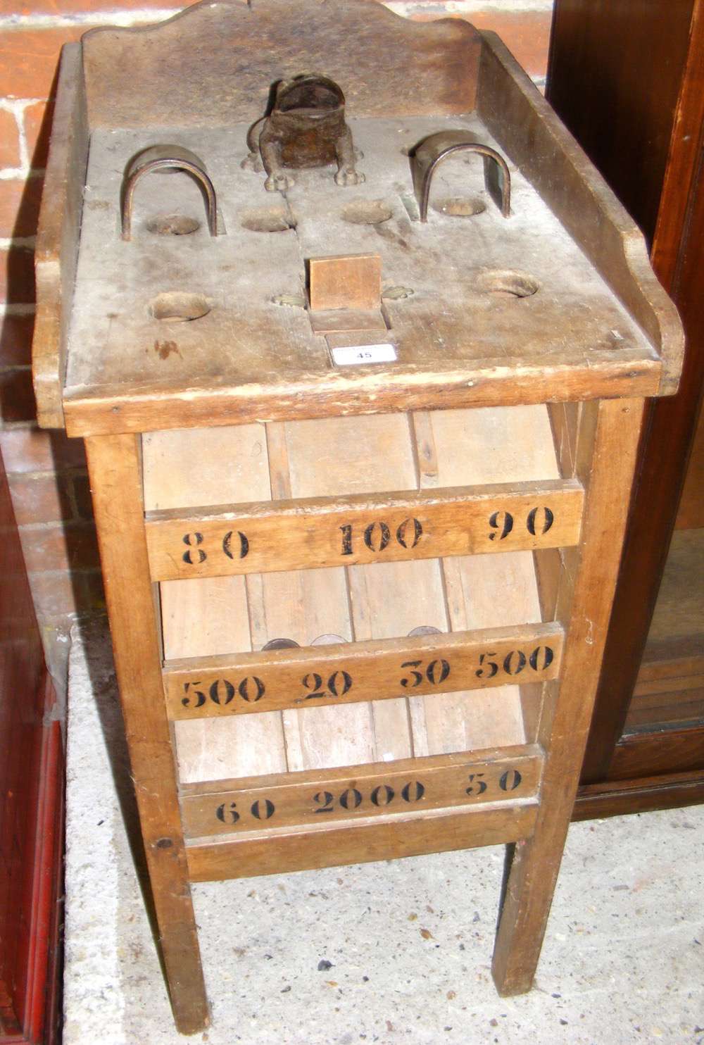 An antique wooden amusement arcade game