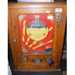 A "Fivewin" half penny coin in the slot amusement arcade machine