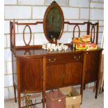 An antique break-front mahogany sideboard with mirrored back