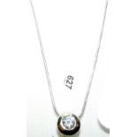 A 14k single stone diamond pendant and chain