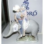 A boxed Lladro figure of Indian boy and girl riding elephant - 24cm high