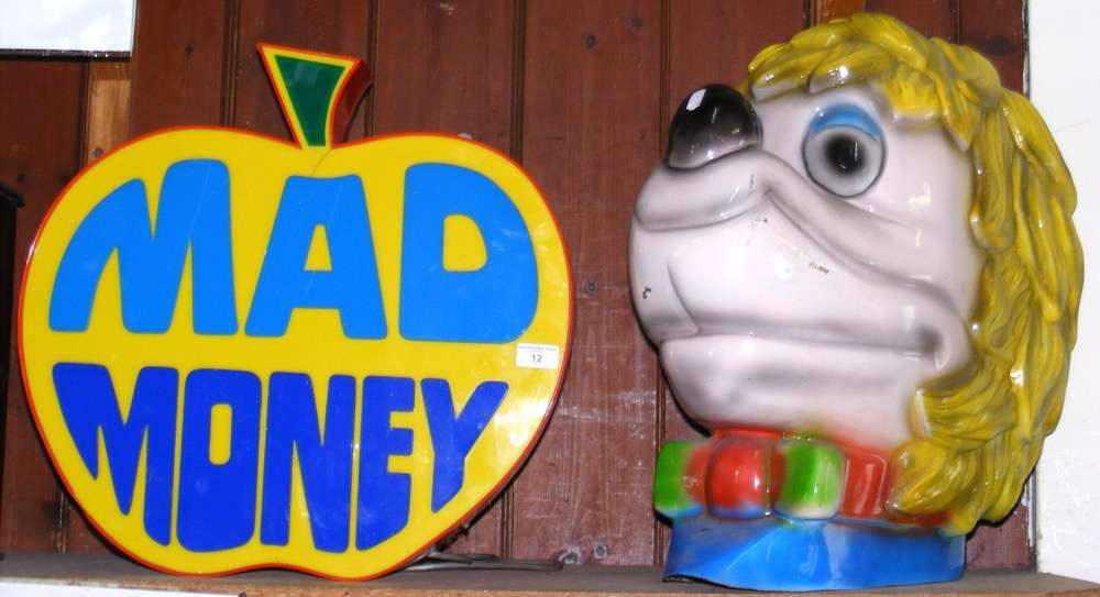 An illuminated advertising arcade display "Mad Money", together with a moulded head