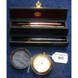 Two boxed surgical scalpels and a compensated pocket barometer in leather case
