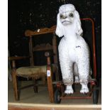 An antique child's chair and a Tri-ang pull-a-long Poodle