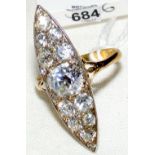 An 18ct gold boat shaped eleven stone diamond dress ring, the centre diamond in excess of 1 carat