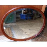 An oval antique wall mirror