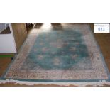 A 430cm x 295cm washed Chinese carpet with sea green ground, floral motifs and border