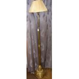 An adjustable brass column standard lamp complete with shade