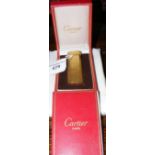 A Cartier cigarette lighter in original box complete with original guarantee