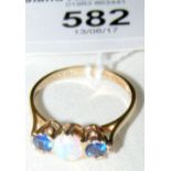 A 9ct gold three stone ring with centre opal flanked by two blue stones
