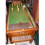 A coin operated bar billiards table - complete with balls and cues