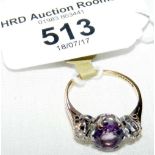 An amethyst and diamond three stone ring in 18ct gold setting