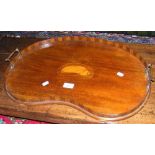 An Edwardian kidney shaped mahogany serving tray with shell inlay