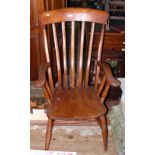 An antique slat back kitchen armchair