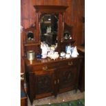 An Edwardian mirrored back sideboard with drawers and cupboards below