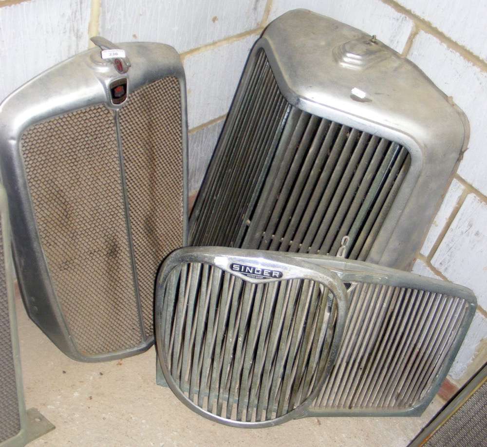 A Morris Eight chrome radiator grille, together with a Singer and two others