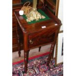 An antique mahogany pot cupboard on turned supports