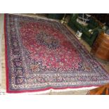 Turkish carpet with red ground and floral border - 11.5ft x 8ft
