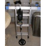 Metal detector and a folding set of decorator's ladders