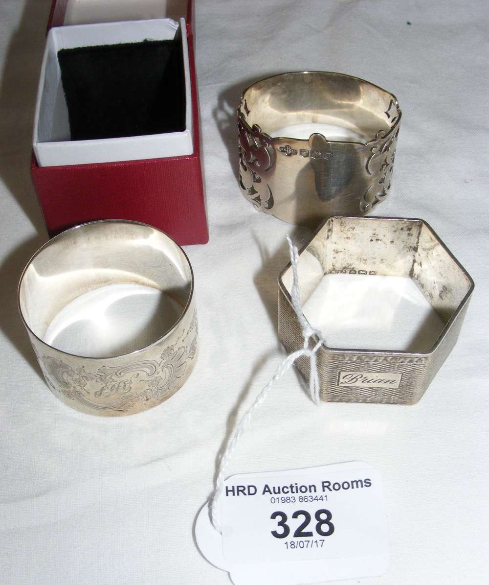 One boxed and two other silver napkin rings