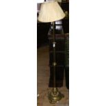 An adjustable brass column standard lamp complete with shade