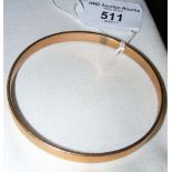 A 9ct gold bangle with metal filled core