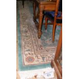 A washed Chinese carpet with sea green ground, floral motifs and border - 430cm x 295cm