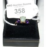 A 9ct gold jade and amethyst three stone ring