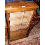 A tambour fronted oak filing cabinet