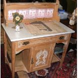 A Victorian pine washstand with tiled back