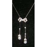 A diamond "Bow and Drop" pendant and chain with two brilliant cut diamonds