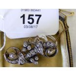 An unhallmarked Victorian diamond brooch with 24 cut diamonds in scroll setting