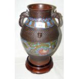 A Japanese cloisonne/champleve vase with elephant mask handles, chrysanthemum design and carved wood