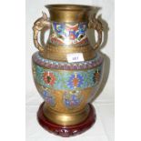 A Japanese cloisonne/champleve vase with elephant mask handles, flower and shield design on carved